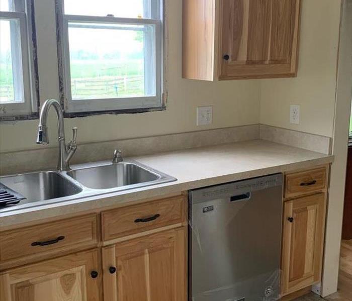 A kitchen with new oak color cabinets and fresh paint. 